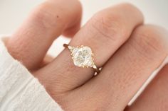 a woman's hand with a diamond ring on it