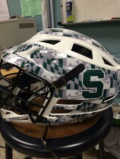 a football helmet sitting on top of a stool