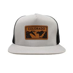 Colorado Elevation mountains faux leather patch in rawhide. Available in silver gray or black. Flat bill cotton twill front. Mesh back with adjustable snapback Gray Hat With Logo Patch And Curved Brim, Urban Trucker Hat With Logo Patch For Outdoor, Logo Patch Snapback Hat For Outdoor Activities, Logo Patch Flat Bill Snapback For Outdoor Activities, Flat Bill Snapback Hat With Logo Patch For Outdoor, Outdoor Snapback Hat With Logo Patch, Outdoor Snapback Hat With Flat Brim And Logo Patch, Flat Brim Trucker Hat With Logo Patch For Outdoor, Gray Trucker Hat With Logo Patch