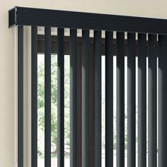 an open window with black vertical blinds on it