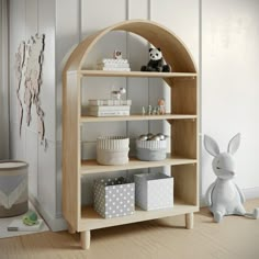 a wooden shelf filled with cupcakes and other items next to a stuffed animal