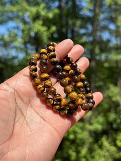 Growl your way to fashion and style with our Tiger Eye Bracelet. This sleek and sparkly bracelet is designed to make you feel like the king (or queen) of the jungle, and features a glossy tiger eye stone that really catches the light. Telescope your style to a whole new level with this wild accessory! Brown Gemstone Beads Crystal Bracelet For Healing, Brown Crystal Bracelet With Gemstone Beads For Healing, Gift Brown Crystal Bracelet Hand Wrapped, Hand Wrapped Brown Crystal Bracelet Gift, Gift Brown Hand Wrapped Crystal Bracelet, Gift Hand Wrapped Brown Crystal Bracelet, Brown Gemstone Beads Bracelets For Healing, Spiritual Brown Gemstone Beads Bracelets, Spiritual Brown Bracelets With Gemstone Beads