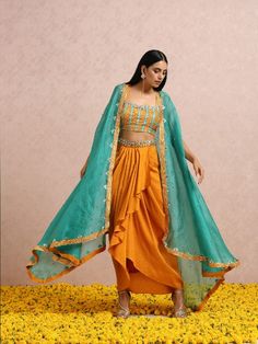 This fusion set features a rust embellished top and dhoti with an embroidered belt. To add a modern twist,it has a teal embroidered silk organza cape. Color: Pink Fabric: Silk and Organza Note: The product will be shipped within 30-35 days of order placed Wash care - Dry Clean Only. Do not use heavy Iron Dhoti Skirt With Crop Top, Dhoti Dresses For Women, Royal Blue Lehenga, Teal Crop Top, Dhoti Skirt, Ruffle Lehenga, Silk Organza Fabric, Organza Cape, Aladdin Jr