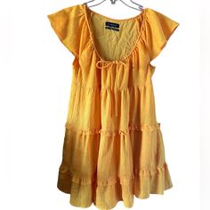 Urban Outfitters Bea Tiered Frock Yellow Babydoll Dress Size Xs Nwot Perfect For Casual Or Spring Dress Short Sleeve Tiered Ruffle Dress For Beach, Summer Sundress With Short Sleeves And Ruffles, Summer Sundress With Ruffles And Short Sleeves, Casual Short Sleeve Sundress With Ruffles, Yellow Cotton Dress With Ruffle Hem, Cotton Tiered Ruffle Dress For Vacation, Orange Ruffled Mini Dress For Beach, Orange Ruffled Beach Mini Dress, Cute Cotton Tiered Mini Dress