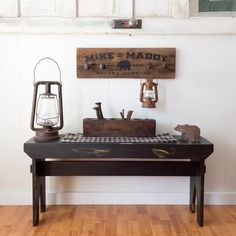 a wooden bench sitting on top of a hard wood floor next to a light fixture