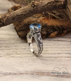 "A stunning vintage sterling silver engagement ring for the beautiful bride. An engraved branch with the texture of a real tree is adorned with twisted patterns and a large blue as clear sky topaz that plays with all its facets. A gift to make a special day magical. DETAILS: Stone - 9mm Natural Swiss Topaz Metal - recycled solid Sterling Silver Dimensions - width 9mm (0.35 in.), band width - 2mm (0.196 in.) Finish - oxidized (shiny at your request) View all silver branch rings:  https://etsy.me/3BrAI3m HOW TO ORDER ▪   Simply choose your ring size and a gemstone in dropdown menus. ▪   Add an engraving you'd like to have inside in the 'Personalization Box' (optionally). ▪   Feel free to contact me if you want to change anything about the ring design (dimensions, additional stones, material Nature-inspired White Gold Wedding Rings, Nature-inspired Solitaire Jewelry For Weddings, Nature-inspired Wedding Rings With Prong Setting, Unique Engraved Jewelry For Wedding, Unique Engraved Wedding Jewelry, Nature-inspired Wedding Jewelry With Prong Setting, Sterling Silver Topaz Ring For Wedding, Unique Sterling Silver Topaz Ring For Wedding, Nature-inspired Wedding Jewelry With Accent Stones