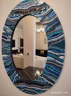 a round mirror with blue and white glass covering it