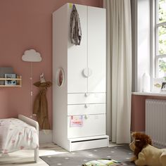 a child's bedroom with pink walls and white furniture