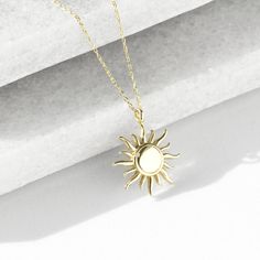 Burning sun figured, handmade 14 K yellow solid gold  tiny necklace. Comes with 14k gold chain. Standart chain length: 45 cm (17 inches) The size of sun is 13 mm (0,51 inches) diameter. Your lovely sun will arrive in a gift box. Choose your choice of chain lenght. Worldwide Shipping. (DHL/FEDEX/UPS/TNT) Please contact to me for any request. Feel the beauty of the sun with a gold sun necklace. It's been loved for ages. Wear it and feel warm, lively, and full of potential. Let the necklace shine o Everyday Sun-shaped Jewelry With Sun Design, Gold Sun-shaped Necklace As A Gift, Elegant Sun Design Pendant Necklace, Sun Pendant Gold, Gold Sun-shaped Necklace For Gift, Gold Sun Necklace, Burning Sun, Sun Jewelry, Tiny Necklace