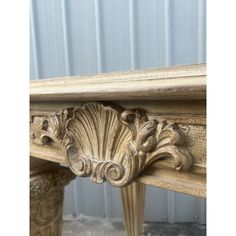 an ornate wooden table with carved details on it