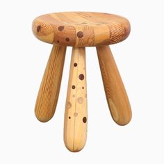 a wooden stool with holes on it