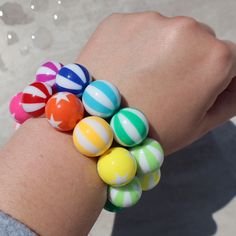 Add a colorful pop of beachy fun to your look with this summer stretchy bracelet. Large acrylic beach ball beads Clear elastic White Beachy Stretch Bracelet For Summer, Summer Beaded Bracelets With Large Beads, Colorful Beaded Bracelets For Beach In Summer, Fun Beaded Stretch Bracelet For Summer, Playful Multicolor Beaded Bracelets For Vacation, Green Stretch Bracelet With Round Beads For Beach, Playful Multicolor Jewelry For The Beach, Fun Plastic Jewelry For The Beach, Casual Summer Bracelets With Round Beads