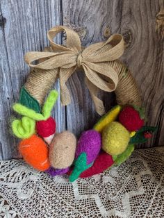 a wreath made out of yarn and felt with a bow