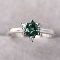 ◆ The ring is handcrafted from sterling silver and decorated with a dazzling 6*6 mm green sapphire and CZs. It is suitable for engagement/anniversary/daily occasion. ◆ Production Description: Main stone Type: Lab Green Sapphire Main Stone Shape: Trillion Cut Main Stone Size: 6*6 mm(0.96ct) Side stone: CZ Metal: 925 Sterling silver - Other options available in the drop down menu ◆ Customization: √Free for Add Engraving √Other Metal Type Available √Other Gemstones & Shapes Available √Personali Green Diamond Birthstone Ring With Brilliant Cut, Green Diamond Birthstone Ring For Promise, Green Diamond Ring With Princess Cut And Accent Stones, Green Sapphire Rings With Prong Setting, Green Princess Cut Diamond Ring With Accent Stones, Green Sapphire Ring With Center Stone, Green Emerald Ring With Center Stone For Promise, Green Diamond Birthstone Ring With Accent Stones, Green Emerald Ring With Brilliant Cut For Promise