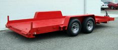 a red trailer parked in front of a building