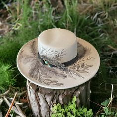 Grey Color Wide Brim Bolero Hat Shown. This Hat Style comes in Ivory/Beige, Grey & Pink and Black Burned designs using Pyrography techniques. Each Hat is burned freehand. He stencil, therefore each hat is a one of a kind. Each Hat is sealed with a weather proofer, good for 12 months. Hats made by PIPER Hat Co. also come with a signature travel bag and crafted macrame Wall Hanger. Hand Tooled Leather Hat, Bohemian Flat Brim Hand Painted Hat, Artistic Short Brim Hat For Rodeo, Artistic Flat Brim Hat For Rodeo, Artisan Hat With Curved Brim And Feathers, Hand Painted Flat Brim Hat For Rodeo, Artisan Hat With Feathers And Curved Brim, Artisan Wide Brim Hat With Feathers, Artistic Wide Brim Hat For Rodeo