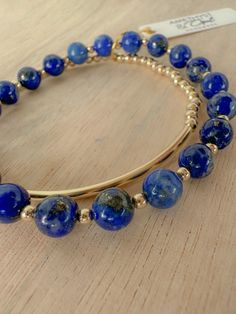 Blue lapis lazuli beaded bracelet stack | gold filled and natural lapis lazuli beads | 2.5mm- 4mm gold filled beads | 4mm- 8mm lapis lazuli beads set of three elastic beaded bracelets or select single style Lapis lazuli is a deep blue gemstone that is prized for the intensity of its color and its ability to uncover inner wisdom and truth. Blue Beaded Jewelry In 14k Gold Filled, Gold Lapis Lazuli Beaded Bracelets With Round Beads, Blue Gemstone Beads Jewelry In 14k Gold Filled, Blue Gemstone Beads Jewelry In 14k Gold, Hand-strung Gold Lapis Lazuli Bracelets, Gold Lapis Lazuli Spiritual Bracelets, Bracelet Stack Gold, Elastic Beaded Bracelets, Blue Bead Bracelet