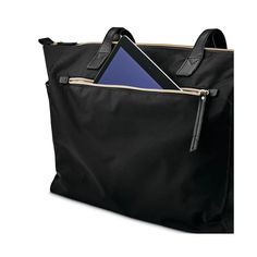 a black tote bag with a blue folder in the pocket and an open laptop on top