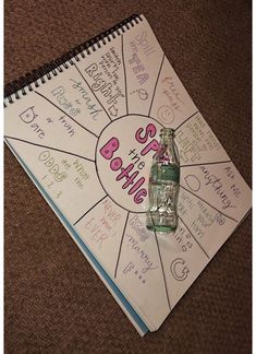 a spiral notebook with writing on it and a bottle in the middle that says baby's birth