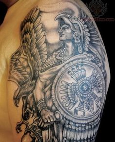 a man's arm with an eagle and shield tattoo design on the left shoulder