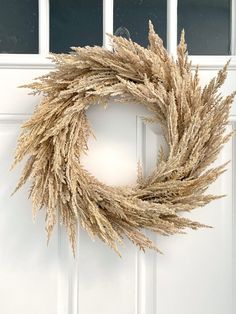 a dried wreath hanging on the front door