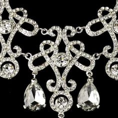 Vintage%20Inspired%20Bridal%20Necklace%20and%20Chandelier%20Earrings%0D%0AAdd%20vintage%20glam%20to%20your%20wedding%20day%20look%20with%20this%20fabulous%20jewelry%20set.%20This%20silver%20plated%20necklace%20and%20chandelier%20earring%20set%20features%20an%20intricate%20scroll%20design%20encrusted%20with%20glistening%20rhinestone%20crystals.%20This%20glamorous%20set%20will%20add%20head-turning%20style%20to%20your%20bridal%20ensemble!%0D%0ASize%3A%20The%20necklace%20is%2014%201%2F2%22%20in%20long%20with%20a%202%22%20extender%2C%20and%20is%202%201%2F2%22%20at%20its%20widest%20point.%20The%20pierced%20chandelier%20earrings%20are%202%22%20long.%0D%0AColor%3A%20Silver.%0D%0AStyle%3A%20ne8387.%0D%0APerfect%20for%20Your%20Modern%20Vintage%20Wedding%20or%20your%20Quinceanera%20celebration!%0D%0A Quinceanera Necklace, Wedding Necklace Set, Crystal Wedding Jewelry, David Tutera, Jewelry Gift Guide, Crystal Statement Necklace, Silver Wedding Jewelry, Bridal Fashion Jewelry, Mon Cheri