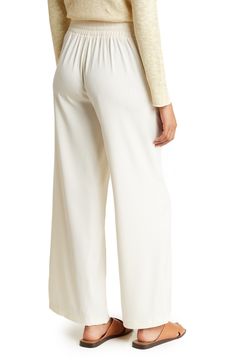 Flowy ankle trousers topped with an elastic waistband are a comfortable workwear essential that will elevate your professional style. 30" inseam, 25" leg opening; 11 1/2" front rise, 16 1/2" back rise (size Medium) Elastic waistband Front patch pockets 98% polyester, 2% spandex Machine wash, line dry Imported Model stats: 5'10", 32" bust, 25" waist, 36" hip. Model is wearing size M. Chic Pull-on Style Bottoms For Daywear, Elegant Wide Leg Pull-on Pants For Work, Business Casual Wide Leg Pull-on Bottoms, Spring Wide Leg Work Pants, Daywear Wide Leg Pull-on Bottoms, Wide Leg Pull-on Bottoms For Daywear, Versatile Business Casual Pants With Elastic Waistband, Versatile Pull-on Bottoms For Daywear, Wide Leg Bottoms With Pull-on Style For Daywear