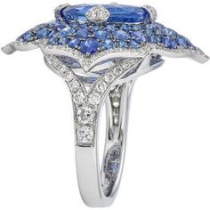 This Pacha Ring in Blue Sapphire from Piranesi is the ultimate statement piece for any jewelry collection. The breathtaking cushion blue sapphire at the center weighs 5.31 carats and is surrounded by 2.87 carats of round blue sapphires. The added touch of a white round diamond weighing 0.80 carats only adds to the ring's brilliance. Set in 18K white gold, this ring will surely make heads turn with its stunning design and impeccable craftsmanship. Whether you're buying it for yourself or as a gif Luxury Sapphire Birthstone Ring, Luxury Sapphire Cluster Ring, Luxury Gia Certified Cushion Cut Sapphire Ring, Luxury Sapphire Birthstone Ring For Formal Occasions, Luxury Round Sapphire Ring, Luxury Blue Diamond Ring With Pave Setting, Luxury Sapphire Ring Cushion Cut Brilliant, Luxury Cushion Cut Sapphire Ring, Luxury Cushion Cut Sapphire Ring With Center Stone