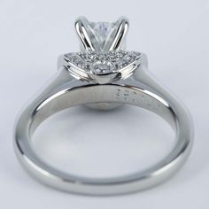 a white gold engagement ring with a princess cut diamond in the center and side stones