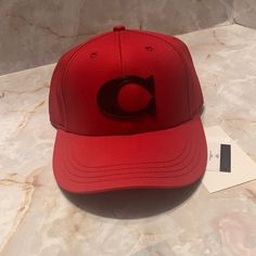 Coach Red Varsity Baseball Cap. This Cap Is Made Out Of Organic Cotton, Red In Color With Their Signature C In Black Leather On It . Size Medium/ Large. Classic Red Snapback Hat With Curved Brim, Classic Red Snapback Cap, Classic Red Snapback Baseball Cap, Classic Red Snapback Hat For Sports, Classic Red Baseball Cap With Curved Brim, Red Adjustable Baseball Cap, Classic Red Baseball Cap, Classic Red Baseball Cap With Curved Bill, Classic Red Trucker Hat