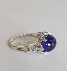 For Sale on 1stDibs - Dalben design white gold ring with an oval cabochon cut Tanzanite weight 8,70 carat and 44 white round brillant cut Diamonds weight 0,23 carats mounted Classic Sapphire Cabochon Rings, Exquisite Formal Gemstone Cabochons, Luxury Diamond Cabochons For Wedding, Elegant White Gold Cabochons For Formal Occasions, Luxury White Gold Diamond Cabochons, Formal Round Gemstone Cabochons, Formal Oval Cabochon Sapphire Ring, Timeless Diamond Rings With Cabochon, Formal Fine Jewelry Gemstone Cabochons