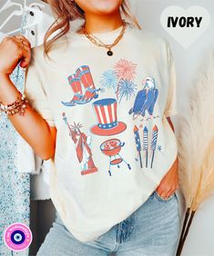 This patriotic 4th of July shirt is perfect for celebrating America's independence day! The red, white, and blue colors are vibrant and the shirt features cute vintage American themed icons on the front. Made from 100% cotton, this shirt is comfortable to wear and will make you feel proud to be an American. It is also great for Memorial Day or Fourth of July celebrations with friends and family. Buy now and show your patriotism for America! SIZE AND FIT: Your shirt will be printed on a high-quality, soft and comfortable unisex t-shirt. Sizes run true to size, which takes the guesswork out of ordering; if you like your t-shirts loose or oversized, you might want to order a size up and if you'd like a more fitted women's style then order a size down. Please refer to our size chart in the pho American Flag T-shirt For 4th Of July, American Style Flag Print T-shirt For 4th Of July, Labor Day Graphic Tee With Flag Print, Labor Day Flag Print Graphic Tee, Labor Day Americana Style Cotton Tops, Labor Day Americana Cotton Tops, Independence Day Crew Neck Top With Flag Print, American Flag Print Relaxed Fit Tops, White American Style Tops For Memorial Day