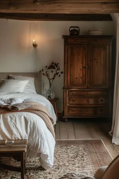 a bed sitting in a bedroom next to a wooden dresser