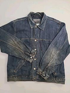 Vintage Joe Boxer Mens Size Large Distressed Denim Jean Jacket Button Up This vintage Joe Boxer jacket is a must-have for any fashion-forward individual. The mid-length coat features long sleeves and a solid blue pattern, made with distressed denim fabric and accented with buttons. The jacket is perfect for any occasion, whether it be for travel, casual outings, or workwear. The unisex jacket has a button closure and pockets for added convenience. It is available in size large and is suitable fo Rugged Long Sleeve Denim Jacket With Pockets, Classic Distressed Long Sleeve Outerwear, Grunge Button-up Denim Jacket For Streetwear, Grunge Denim Jacket With Button Closure For Streetwear, Faded Button-up Denim Jacket, Rugged Denim Jacket With Pockets For Streetwear, Winter Streetwear Denim Jacket With Buttons, Urban Long Sleeve Denim Jacket With Buttons, Rugged Washed Denim Jacket