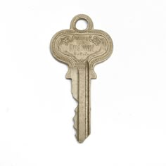 an antique key with the words, please to return on it's back side