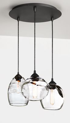 three lights hanging from a ceiling with glass jars on the bottom and one light in the middle