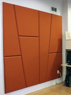 a living room with an orange paneled wall