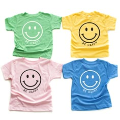 four t - shirts with smiley faces on them, all in different colors and sizes