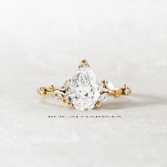 an engagement ring with a pear shaped diamond