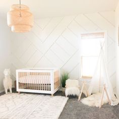 a baby's room decorated in white and neutrals