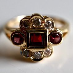 St. Nicholas 14k Gold Garnet and Diamond Ring : Museum of Jewelry Classic Ruby Ring With Rose Cut Diamond Cluster, Elegant Red Birthstone Ring With Rose Cut Diamonds, Heirloom Style Red Garnet Cluster Ring, Heirloom Garnet Cluster Ring For Anniversary, Heirloom Red Garnet Cluster Ring, Red Garnet Cluster Ring, Fine Jewelry Red Garnet Cluster Ring, Red Ruby Multi-stone Ring With Diamonds, Fine Jewelry Garnet Cluster Ring In Red