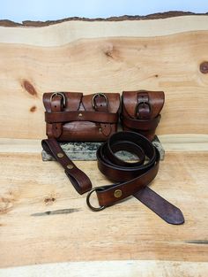 a brown leather handbag sitting on top of a wooden table next to a pair of scissors