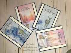 four greeting cards with deer and pine trees on them, all decorated in watercolor