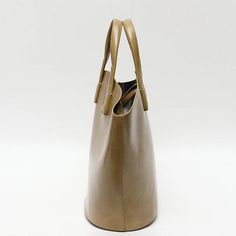 Discover Everyday Elegance Step into the world of sophistication with our Elegant Vegan Leather Tote Bag, a perfect blend of style and functionality. Crafted for the modern woman, this bag is not just an accessory; it's a statement. Whether you're heading to work, a casual outing, or a special event, this tote bag will elevate your style with its simple yet chic design. Product Features Our tote bag stands out with its unique bucket shape, offering a fresh take on the classic tote design. The blend of short handles and long straps provides versatile carrying options, catering to your comfort and preference. Made from high-quality vegan leather, this bag not only looks luxurious but also aligns with ethical fashion choices. The open closure with a secure zip liner bag ensures your belonging Luxury Beige Shoulder Bag For On-the-go, Beige Double Handle Bag With Dust Bag, Beige Double Handle Bags With Dust Bag, Modern Bucket Bags For On-the-go, Beige Double Handle Box Bag With Dust Bag, Modern Bucket Bag With Leather Handles For On-the-go, Modern Satchel Shoulder Bag With Dust Bag, Luxury Large Capacity Bucket Bag For On-the-go, Cream Bucket Bag With Removable Pouch For On-the-go