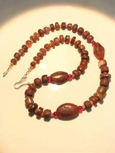 A beautiful collection of very old ancient Carnelian Beads , Carnelian Beads, . They are found in Afghanistan, India, Pakistan and Tibet. They can be used to make a beautiful contemporary designed necklaces. Each bead is authentic and old. Highly collectible 9 pictures are there you can swipe each to see all pictures silver lock 95.5with the necklace Carnelian Jewelry For Meditation In Brown, Brown Carnelian Jewelry For Meditation, Brown Beaded Necklace With Oval Gemstone Beads, Agate Jewelry With Round Wooden Beads, Agate Jewelry With Wooden Beads, Unique Amber Carnelian Beaded Necklaces, Traditional Brown Carnelian Beaded Necklaces, Artisan Agate Jewelry With Wooden Beads, Brown Carnelian Large Beads Gems And Cabochons