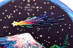 a close up of a colorful piece of cloth with stars and fireworks in the sky