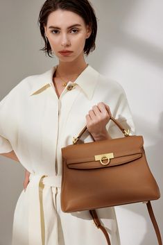 Grace Large Top Handle Bag draws inspiration from vintage door locks and is meticulously crafted with premium Italian full-grain pebbled leather, ensuring both durability and elegance. With its timeless and versatile appearance, this bag is designed with practicality in mind, featuring a well-thought-out interior structure that can comfortably accommodate a 10.2" iPad and all your everyday essentials. Its functional design makes it the perfect choice for those seeking versatility in their daily Timeless Bags For Work With Leather Lining, Timeless Leather Lined Bags For Work, Timeless Leather-lined Bags For Work, Classic Pebbled Leather Shoulder Bag With Detachable Handle, Luxury Pebbled Leather Shoulder Bag For Everyday, Elegant Pebbled Leather Shoulder Bag For Work, Everyday Luxury Epsom Leather Shoulder Bag, Formal Bags With Gold-tone Hardware In Light Luxury Style, Elegant Pebbled Leather Shoulder Bag For Formal Occasions