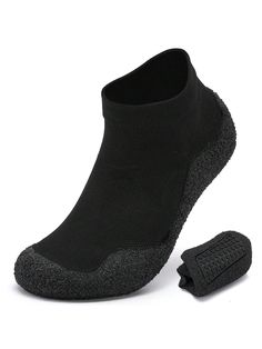 a pair of black slippers on top of a white background