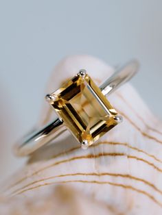 This classic solitaire setting contains a beautiful 1.5ct natural citrine. The emerald cut stone measures approximately 8x6mm. The ring is available in sterling silver, and 14k white, yellow, or rose gold.  Citrine is the birthstone for November.  Please send me a message if you need a size not listed.  *  This ring can be customized with any color center stone. All items are handmade by me in my shop in Manalapan, NJ.  Please message me with any questions. Shipping within the United States is complimentary.   Thank you for exploring my shop! Luxury Citrine Birthstone Ring With Center Stone, Luxury Gold Citrine Birthstone Ring, Luxury Citrine Birthstone Ring, Handmade Luxury Citrine Rings, Luxury Classic Citrine Jewelry, Luxury Citrine Birthstone Ring For Gift, Luxury Handmade Citrine Ring, Zirconia Rings, Solitaire Setting