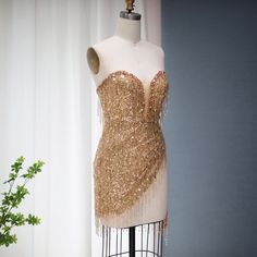 5-7 weeks processing and shipping time This design is from the Bellezza collection. Looking for a dress to make a statement? This copper/gold sequin and tassel mini dress is perfect! This dress is perfect for a birthday party, clubbing, night out or any glamorous occasion.Color may vary due to lighting Material: rhinestones, mesh, polyester Care: hand wash or dry clean only Party Mini Dress With Fringe, Cocktail Mini Dress With Fringe For Party Season, Party Fringe Mini Flapper Dress, Elegant Flapper Dress For Club And Party Season, Fringe Mini Flapper Dress For Parties, Glamorous Beaded Fringe Mini Dress For Night Out, Glamorous Mini Dress With Beaded Fringe For Night Out, Glamorous Club Dress With Tassels, Glamorous Fringe Mini Dress For Party